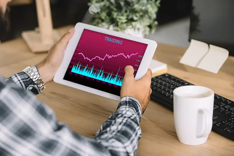 Cropped shot of businessman using tablet with trading on the screen