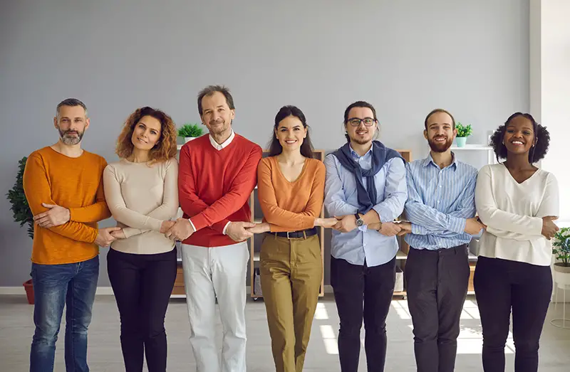 Diverse people group different generation and race ethnicity holding hands together demonstrating teamwork and teambuilding