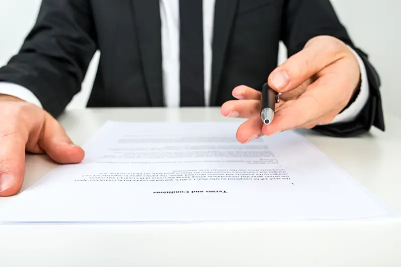 Businessman offering document for signing