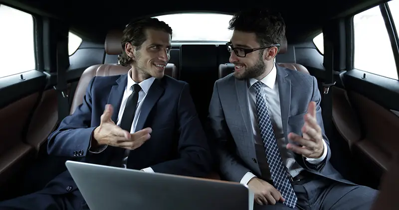 business partners talking,sitting in the car