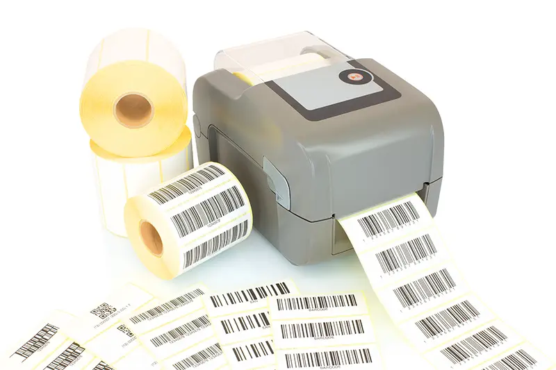 White label rolls, printed barcodes and printer isolated on white background with shadow reflection.