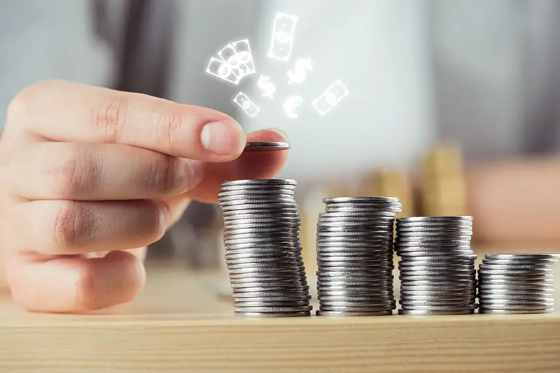 Person stacking coins