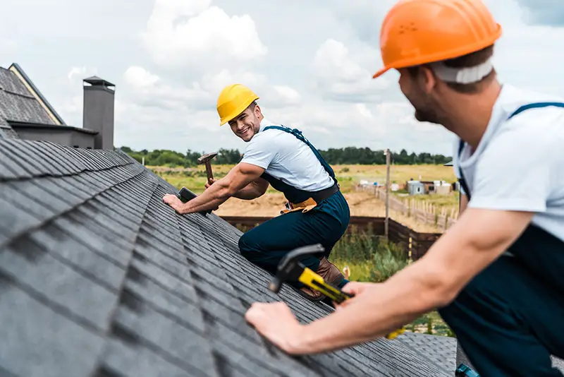 Workers repairing the building roof