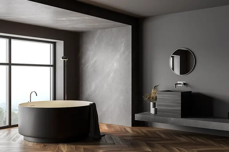 round bathtub and square sink with mirror.