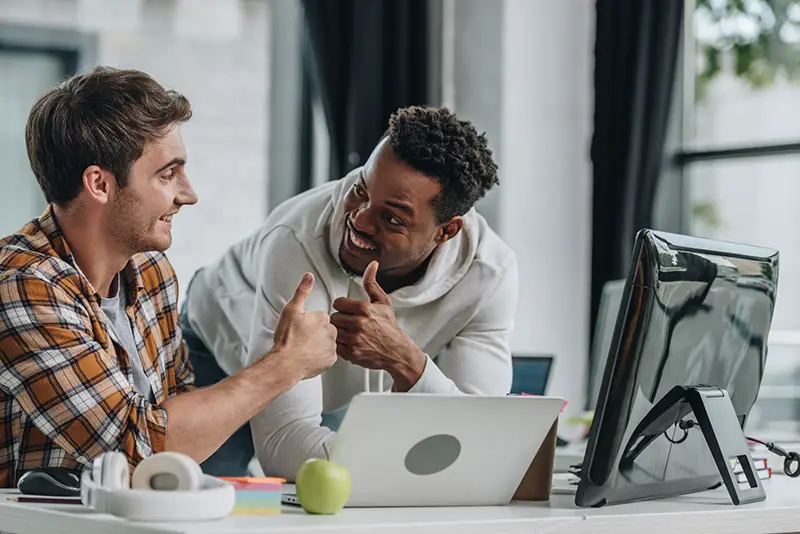 Two happy multicultural programmers