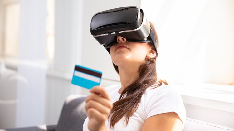 oung Woman With Credit Card Wearing Virtual Reality Glasses