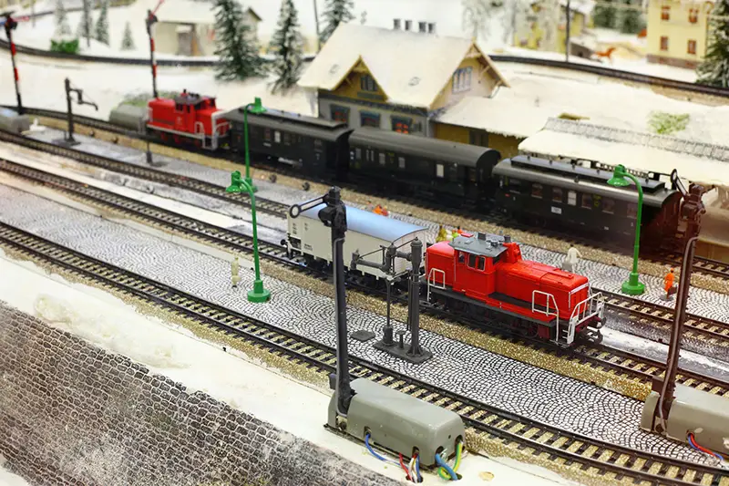 Train models and railroad tracks with winter scenery