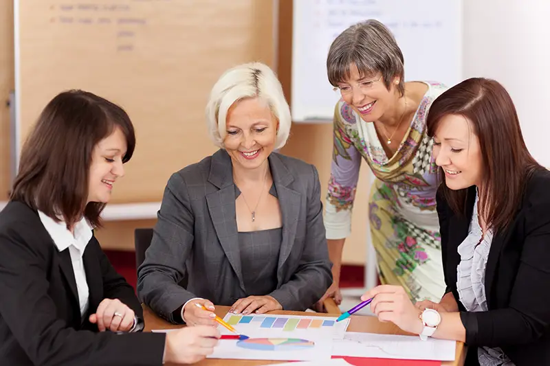 four women working together in a meeting