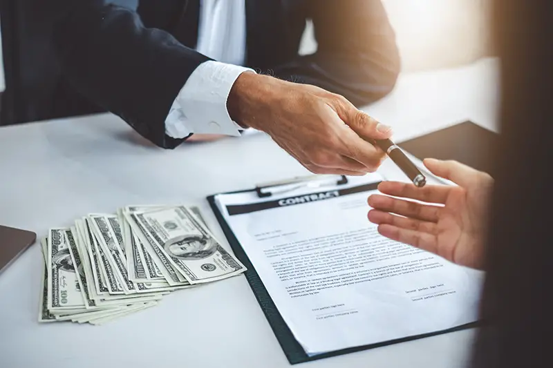 Businessman giving pen to businesswoman for signing contract banking money loaning