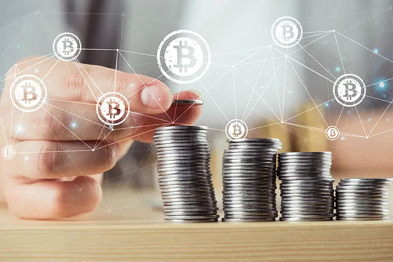 Person stacking bitcoins