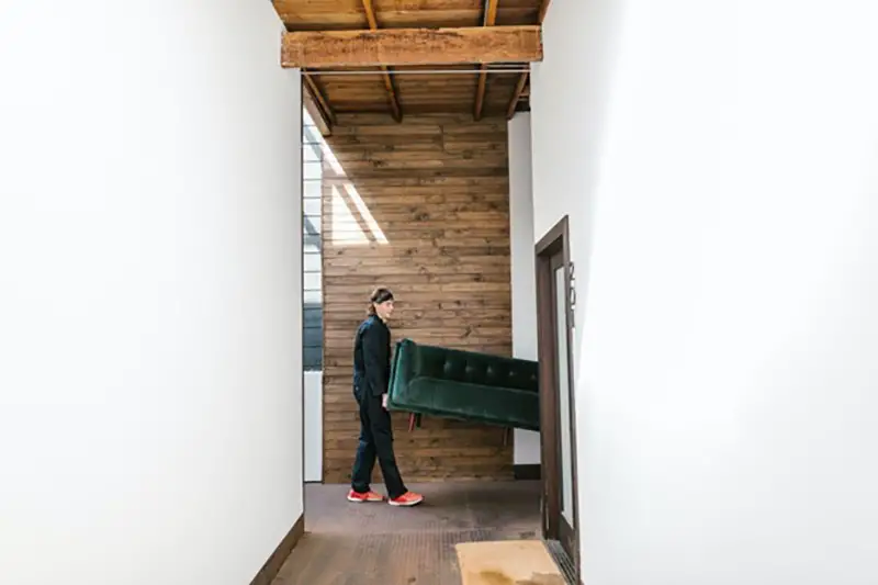 Workers Putting Furniture inside the building