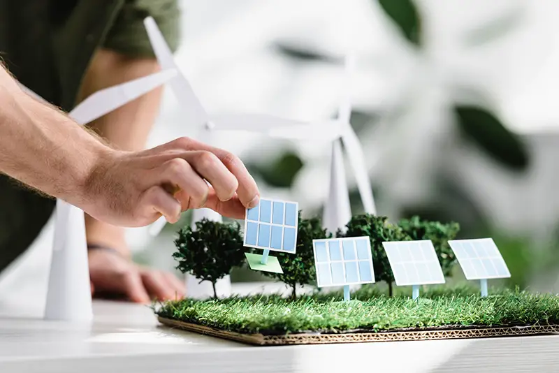 Cropped view of man putting solar panels models