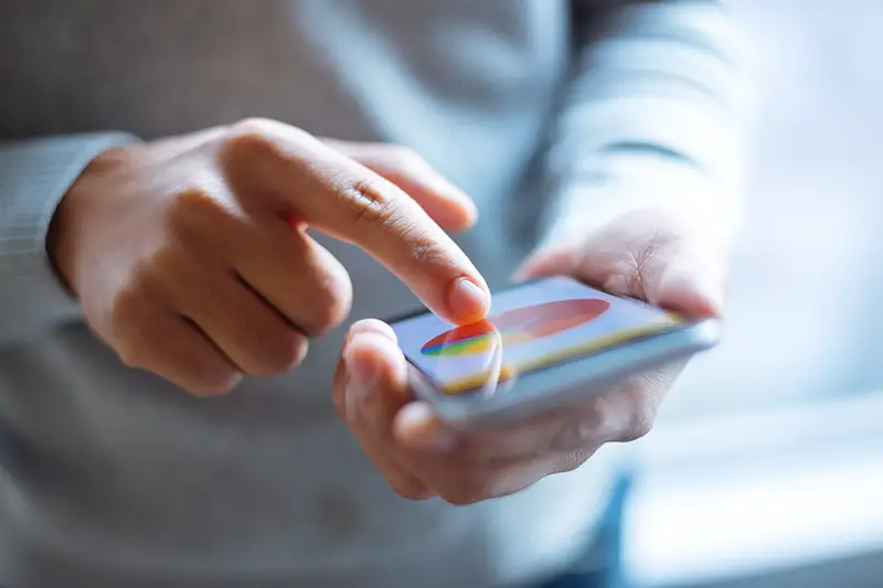 Person using mobile phone with finance chart