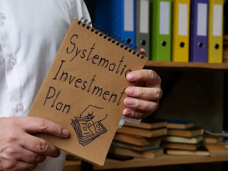 Systematic Investment Plan written on brown notebook