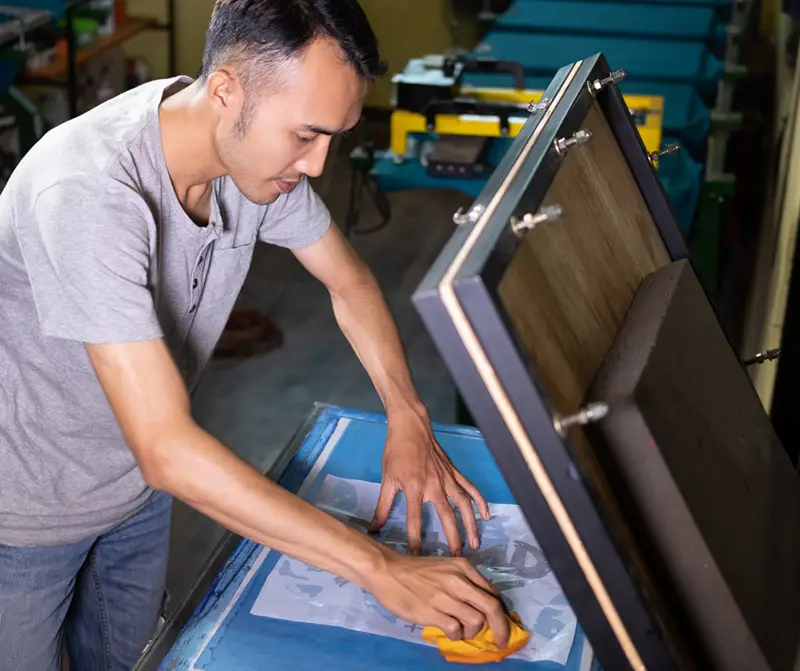 Man working on printing T-shirt