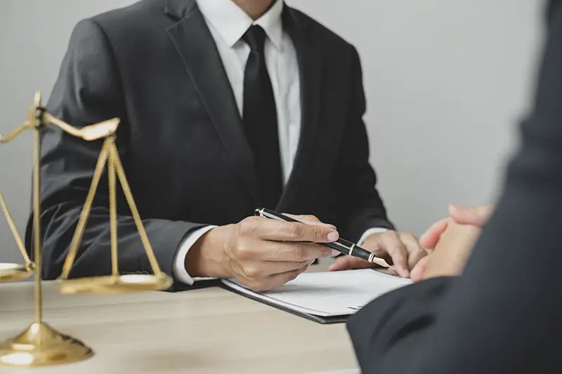 Male lawyers or a judge counseling clients