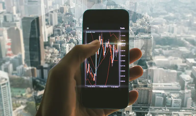 Close up on the smart phone with trading chart