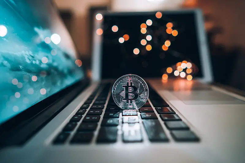 Macro shot of Bitcoins coins on laptop