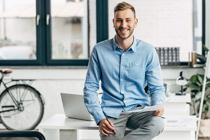 Handsome young businessman holding papers