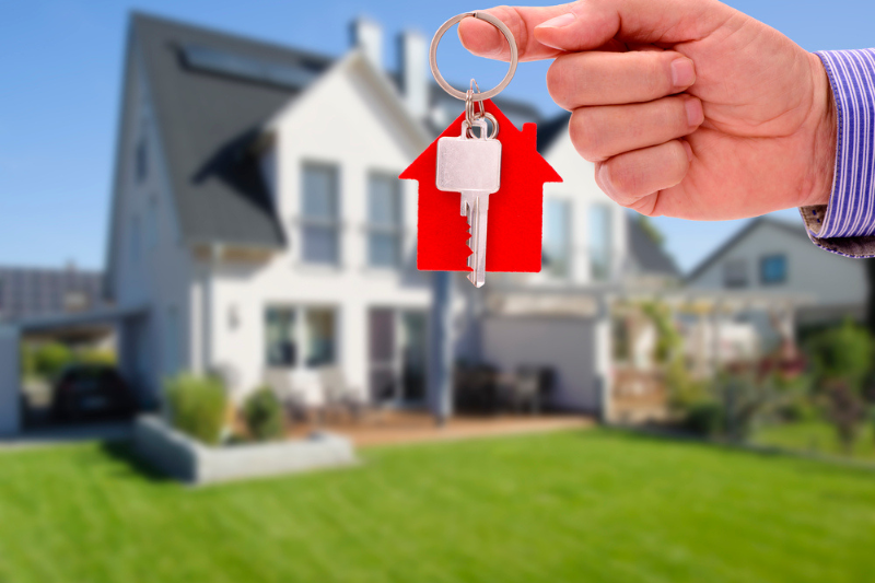 Real estate agent offers a key for your new resident owner