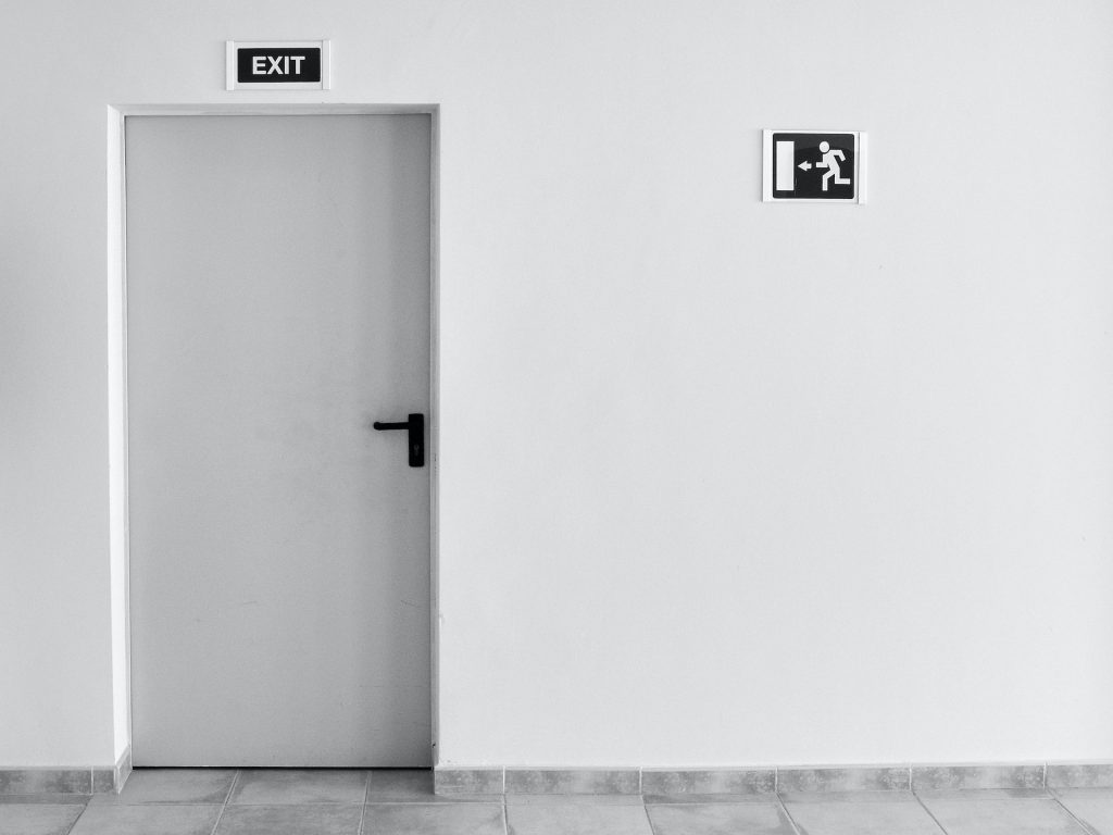 Hallway with door with exit signs