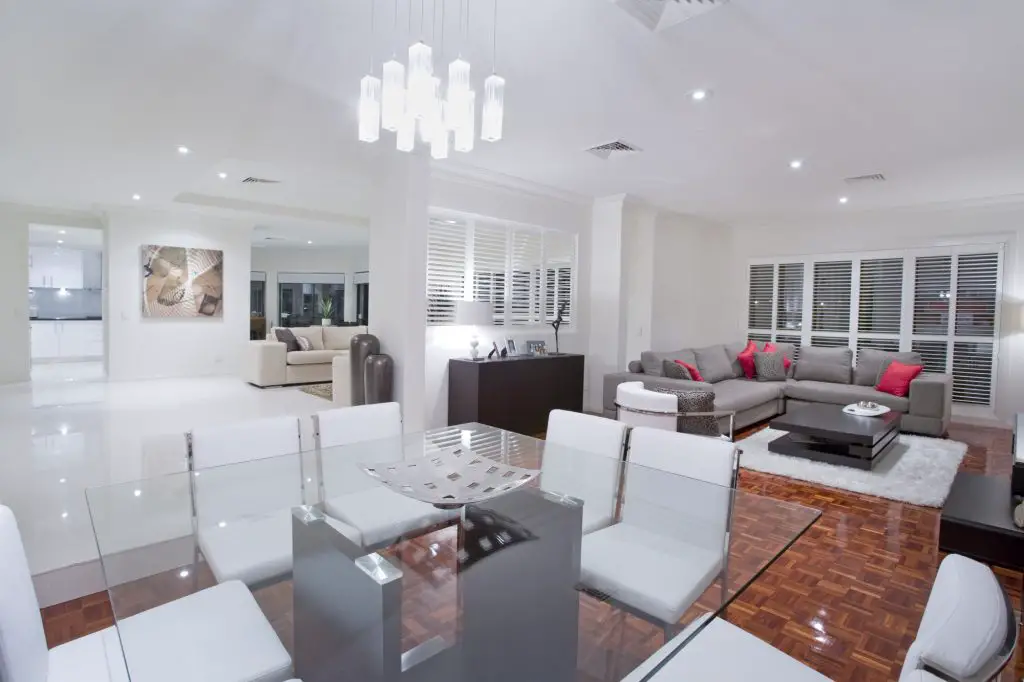 Luxurious dining room with living rooms and kitchen in the background