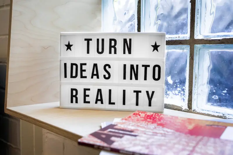 Turn Ideas into Reality! A motivational sign in a Co-Working Space