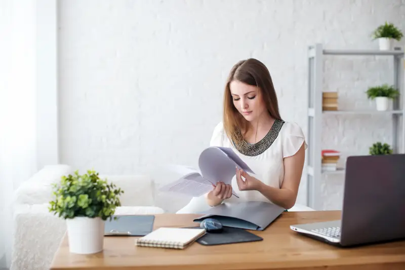Young business woman checking business document