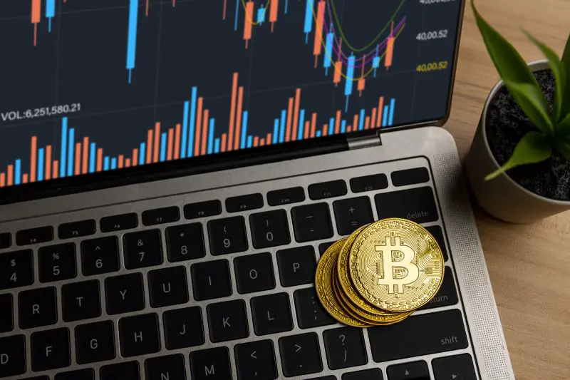 Close up bitcoin on laptop on table at home, cryptocurrency profit and income from investing