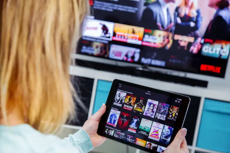 Woman Holding a touch pad and switching channel