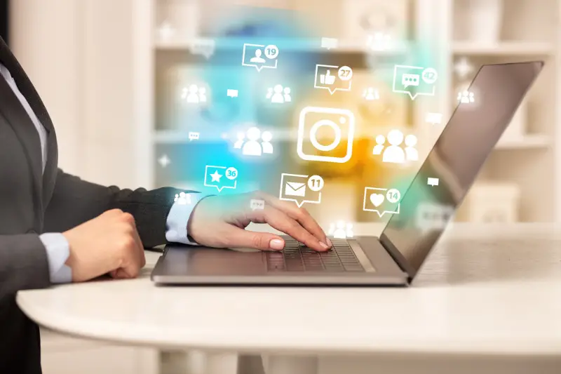 Young person surfing on laptop with social media icon