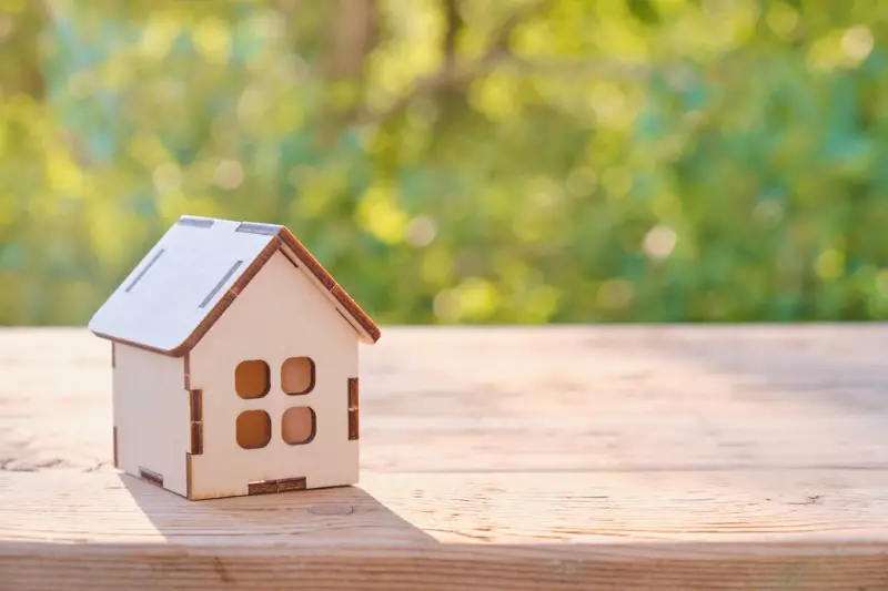 Small home model on wooden table