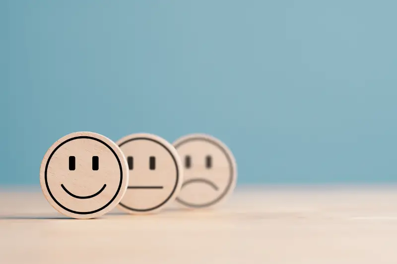 Wooden label with happy normal and sad face icons for experience survey services and products review concept. 