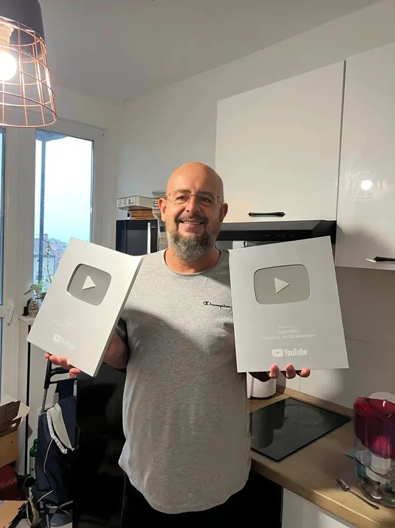 Man holding 2 Youtube silver button