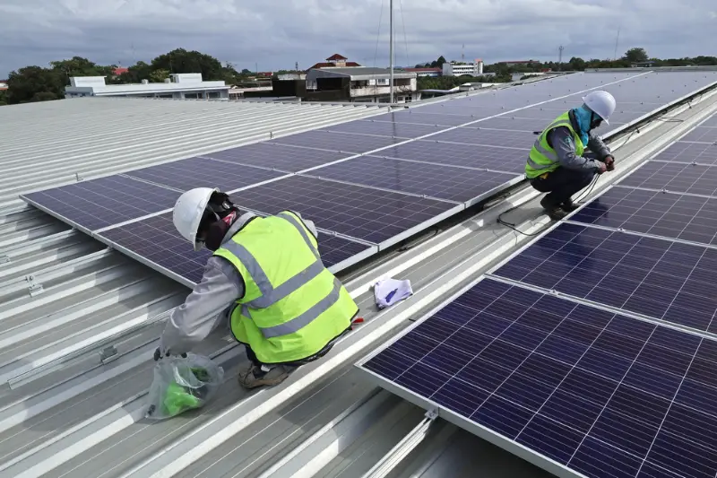 Technician Connecting Cable of Solar Rooftop