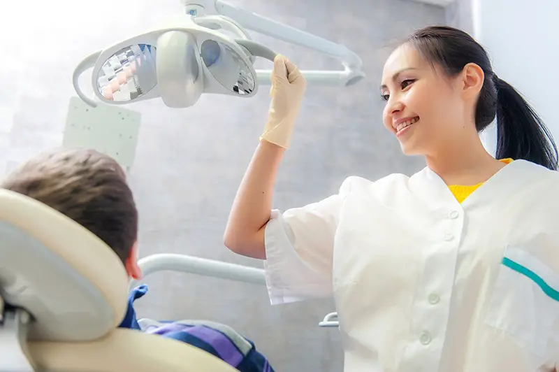 Portrait of a friendly dentist in dental clinic