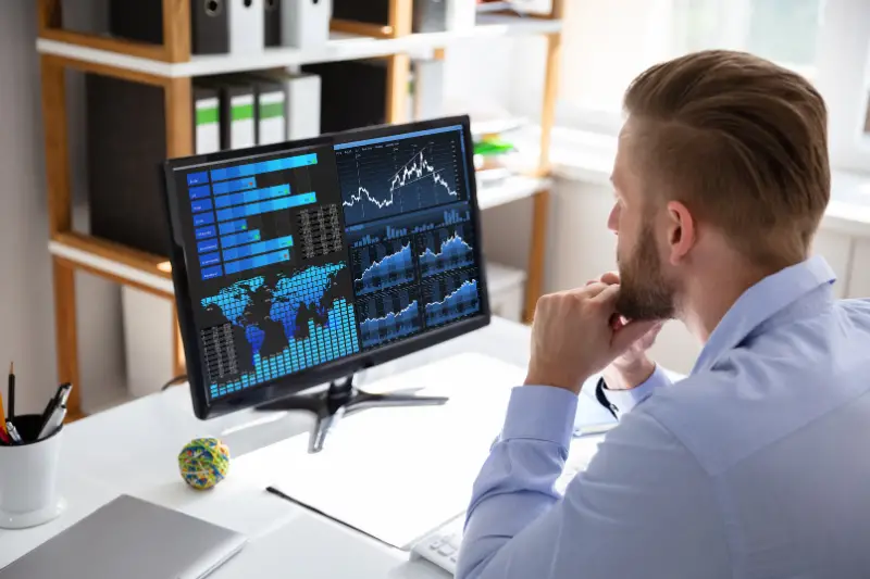 Businessman Analyzing Graph On Laptop