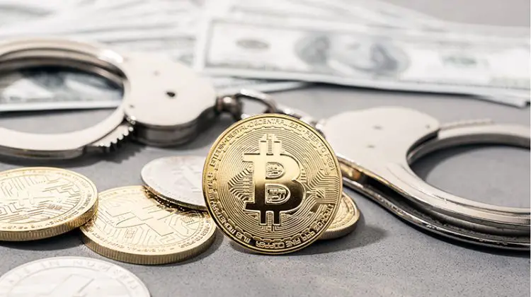 Crypto crime fraud concept. Bitcoin and crypto coins, handcuffs and US dollar banknotes