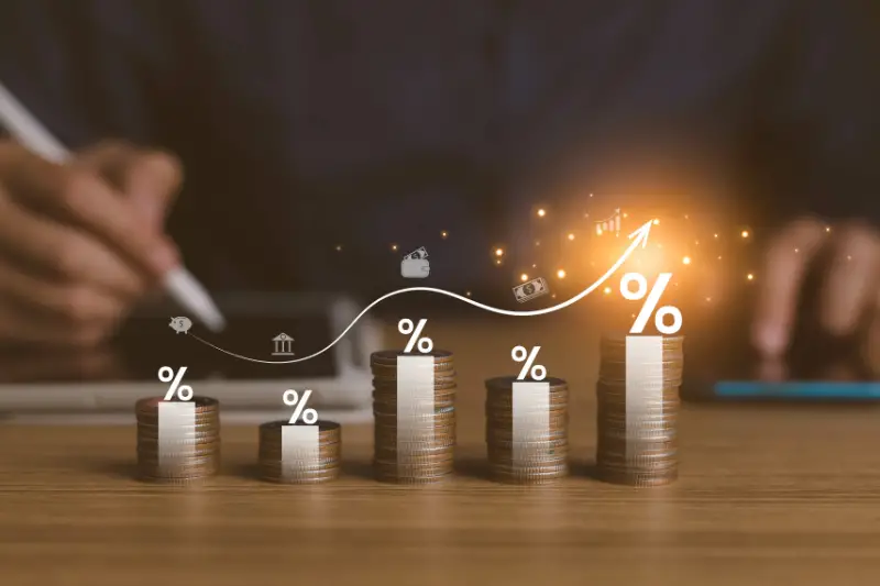 pile of coins and upward direction percentage symbol.