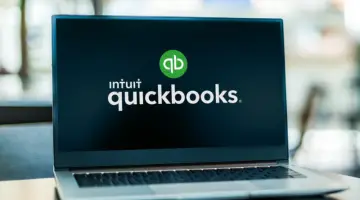 Computer laptop displaying Quickbooks accounting logo