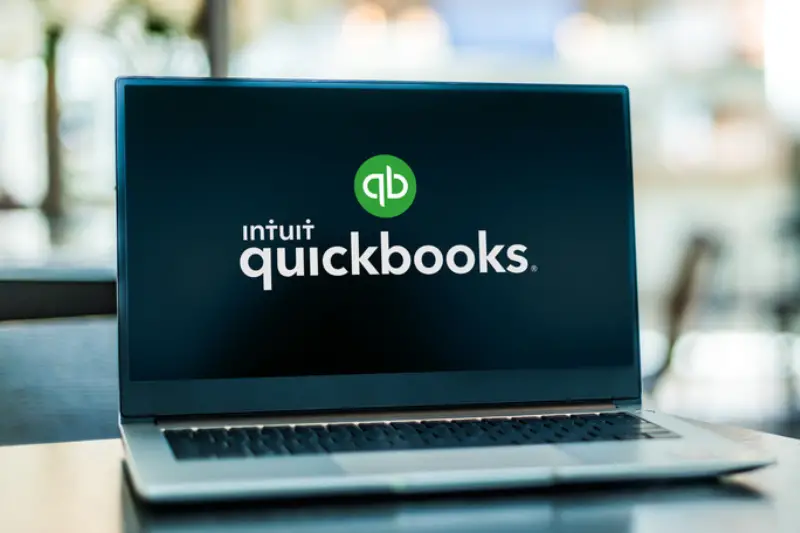 Computer laptop displaying Quickbooks accounting logo