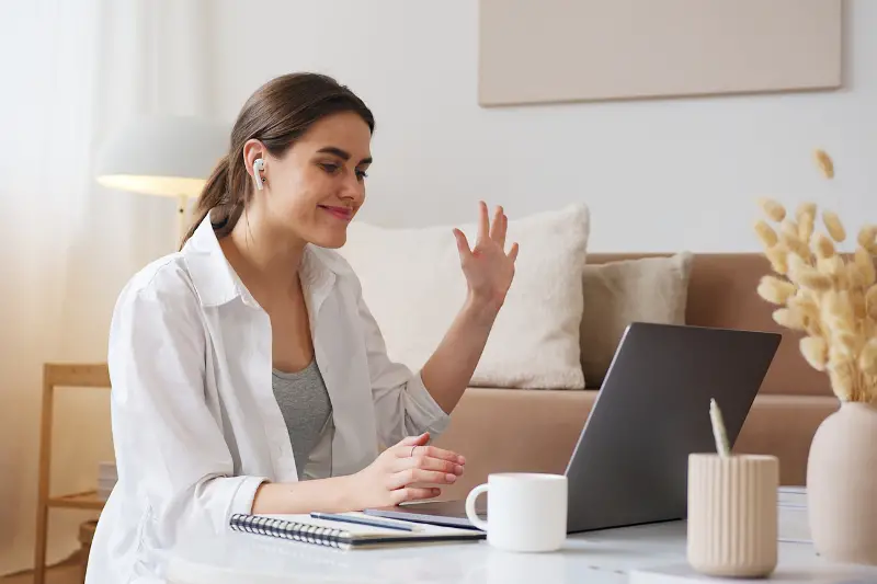 Cheerful woman having video call via laptop