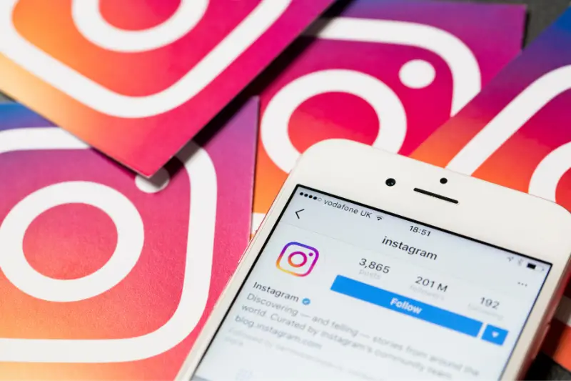 Smartphone shows the instagram app with instagram logos