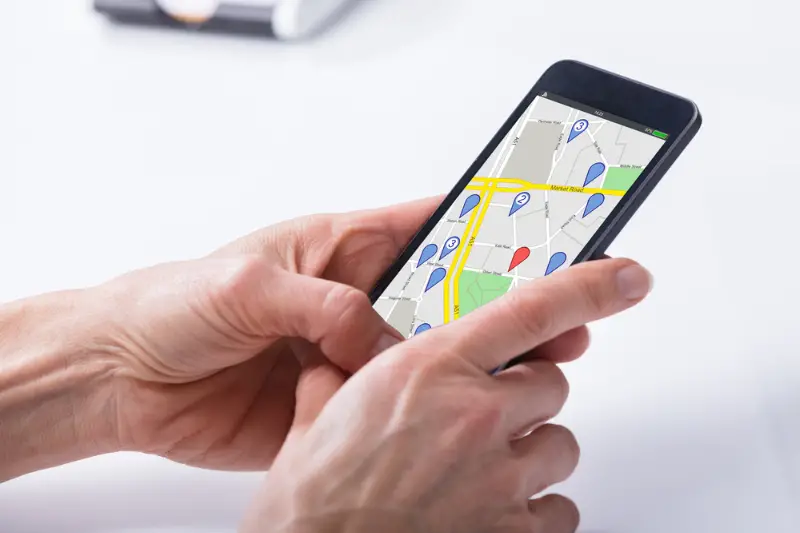 Close-up Of A Person's Hand Using GPS Navigation Map mobile phone