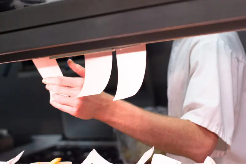 Man receiving orders in a restaurant