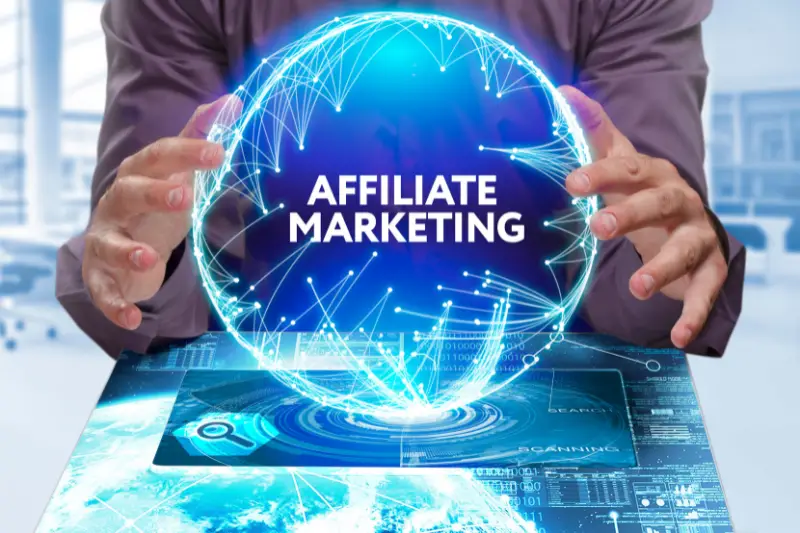 Young businessman shows the word on the virtual display of the future: Affiliate marketing