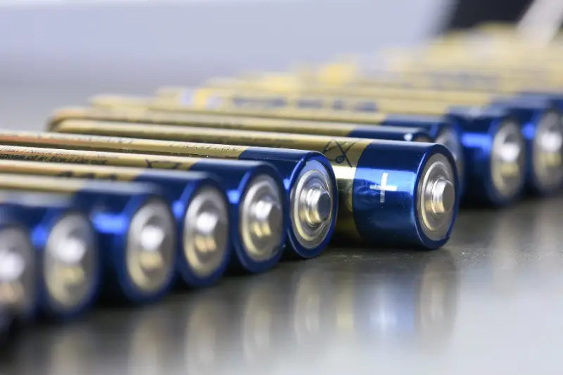 AAA alkaline batteries in perspective on metal background