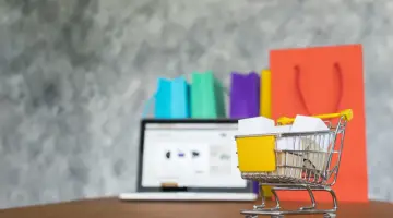Laptop and shopping bags, online shopping concept
