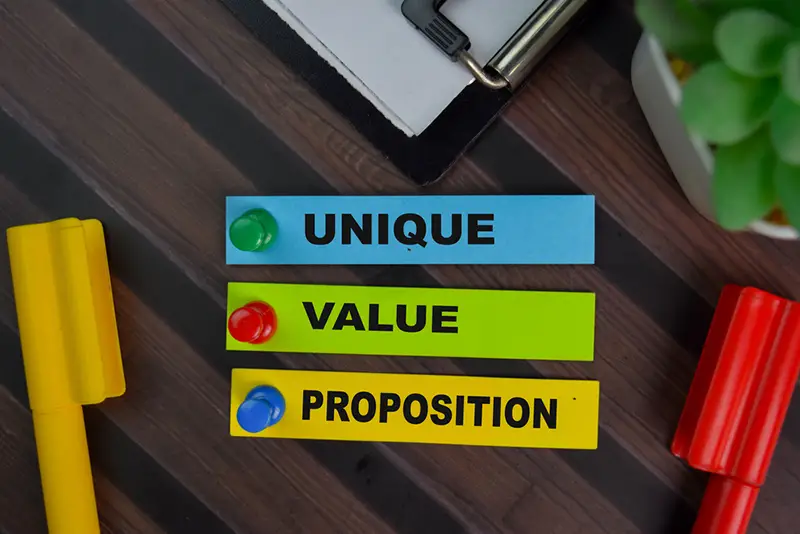 Unique Value Proposition write on sticky notes isolated on wooden table