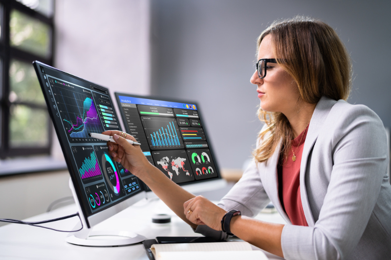 Analyst Women Looking At KPI Data On Computer Screen